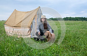 Girl with dog at camping