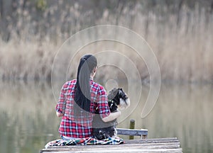 Girl with dog on the dock