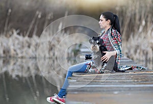 Girl with dog on the dock