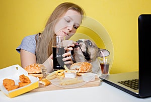 Girl and dog eating fast food