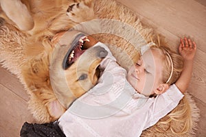 Girl, dog and hug together on floor in living room and golden retriever, kid and relaxing with pet on lounge carpet