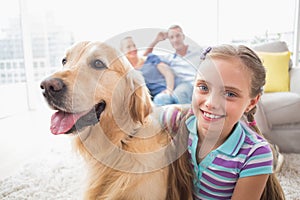 Girl with dog while parents relaxing at home