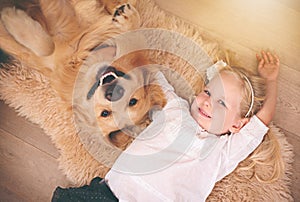 Girl, dog and portrait together on floor in living room or golden retriever, kid and smiling with pet above lounge