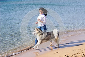 Girl dog running beach