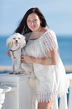 Girl with dog on seafront
