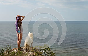 Girl and dog standing on precipice photo