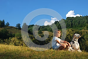 Girl with a dog watching sunset