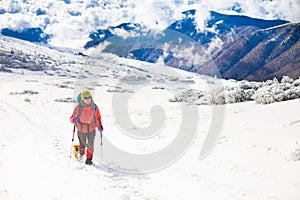 Girl with dog in winter mountains.