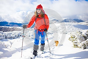 Girl with dog in winter mountains.