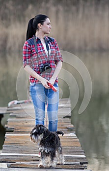 Girl with dog on wooden dock