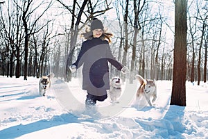 Girl with dogs in winter park