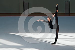 Girl doing the balance in hall rhythmic gymnastics
