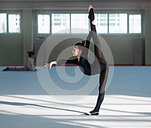 Girl doing the balance in hall rhythmic gymnastics