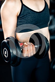 Girl doing bicep exercise with dumbbells