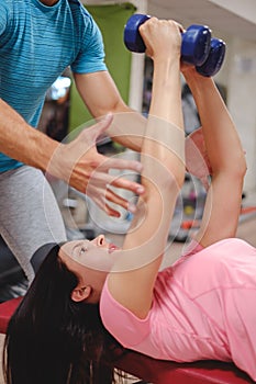 Girl doing chest flys with trainer help