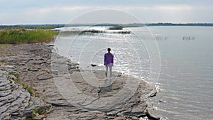 The girl is doing fitness on the lake shore