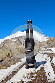 The girl doing the headstand in front of the Mount Elbrus, North Caucasus