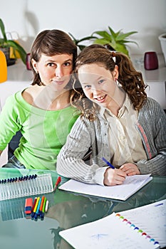 Girl doing homework with her mom