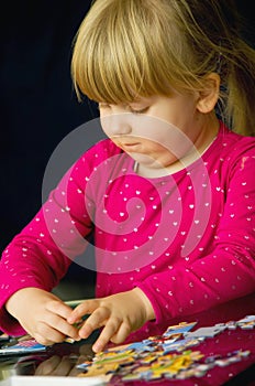 Girl doing jigsaw puzzle