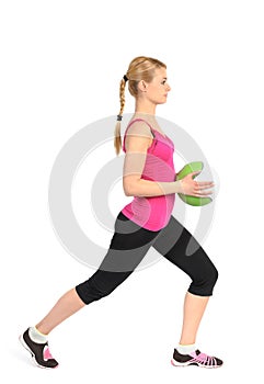 Girl doing lunges exercise with medicine ball