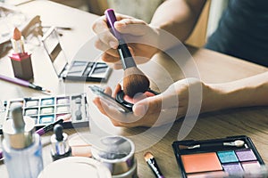 Girl doing makeup on dressing table