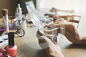 Girl doing makeup on dressing table