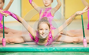 Girl doing rhythmic gymnastics with Indian clubs