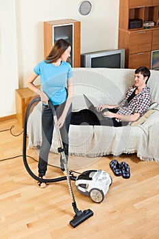 Girl doing room cleaning with vaccuum cleaner