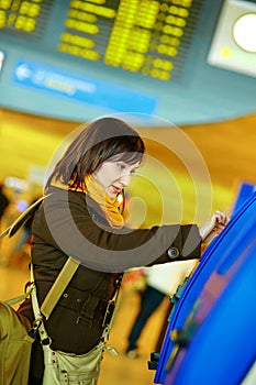 Girl doing self-checkin in the airport
