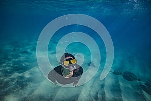 A girl doing snorkeling in tropical water