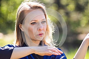 A girl doing tai Chi exercises in a green Park on a Sunny day close up