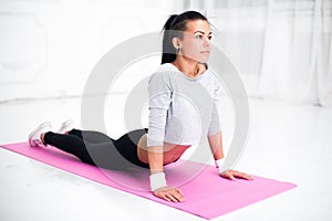 Girl doing warming up exercise for spine, backbend