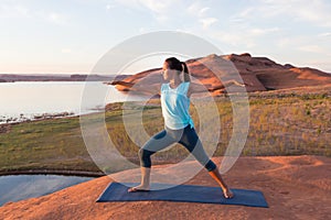 Girl Doing Warrior Yoga by the Lake