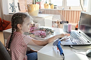 Girl doing wreath with toilet roll tube via online master class, zero waste Easter celebration