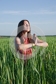 Girl doing yoga against nature