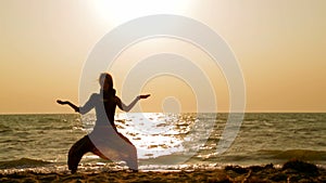 Girl doing yoga on the beach