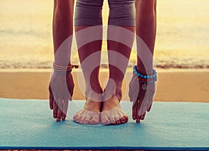 Girl doing yoga exercise on beach