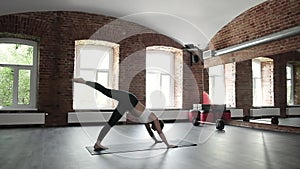 girl doing yoga exercises, standing in downward facing dog pose asana, bakasana