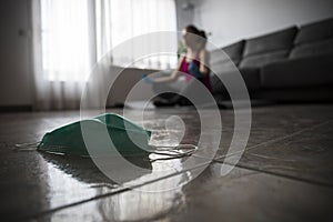 Girl doing yoga at home after breaking free from the protective mask from the coronavirus, covid-19