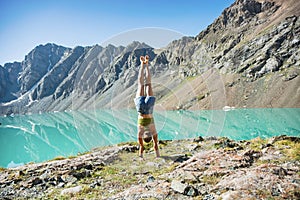 Girl doing yoga near wonderful mountain landscape, lake, highland, peak, beauty world. Picturesque view near Alakul lake