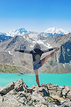 Girl doing yoga near wonderful mountain landscape, lake, highland, peak, beauty world. Picturesque view near Alakul lake