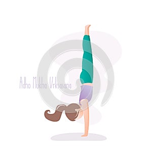 Girl doing yoga pose, Handstand or Adho Mukha Vrksasana asana in hatha yoga
