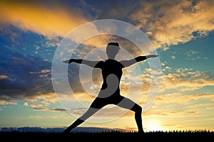 Girl doing yoga at sunset