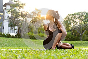 Girl doing yoga at sunset in Thailand in the park