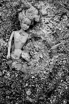 Girl doll blow apart and lying in pile of ash