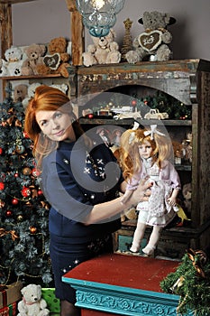 Girl with a doll in Christmas