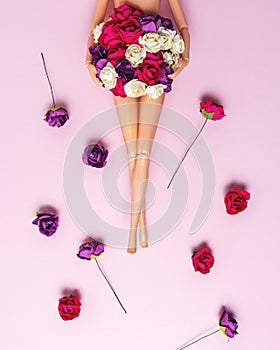 Girl doll with colorful flowers on pink background. Creative minimal fashion or love concept