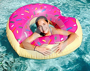 Girl in Donut Float in Pool