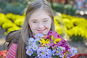Girl with Down syndrome in autumn park.