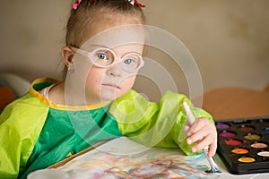 Girl with Down syndrome draws paints photo